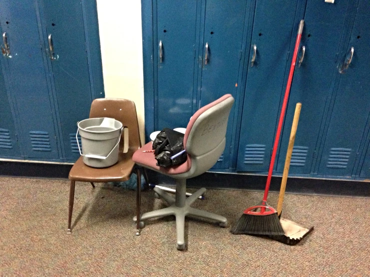 a bucket and mop are on the school desk