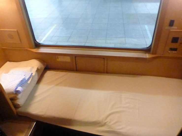 there is a single bed with a mattress on it