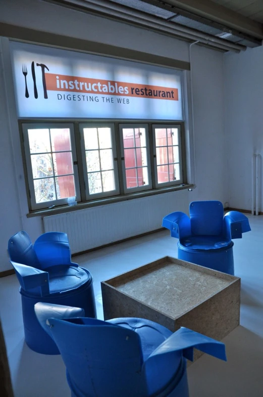 a couple of blue chairs sitting next to a large box