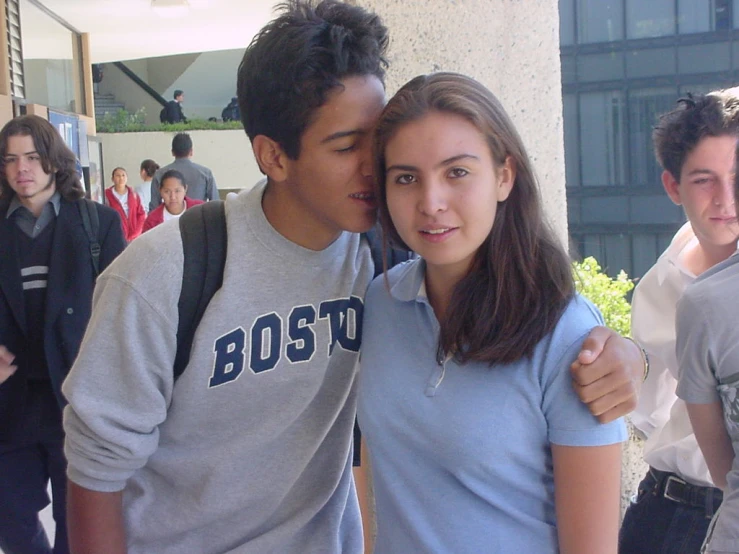 a man kisses a young woman on the forehead