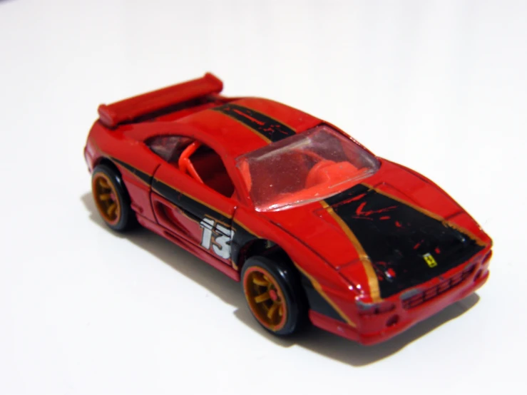 an action hero toy of a ferrari type car