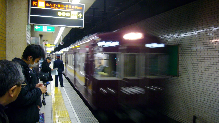 several people are on a platform near a train