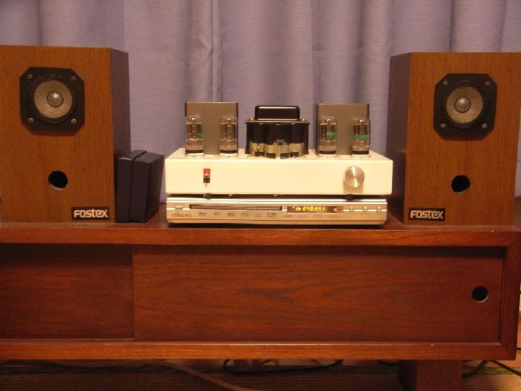 an stereo sitting on a desk with speakers in the back