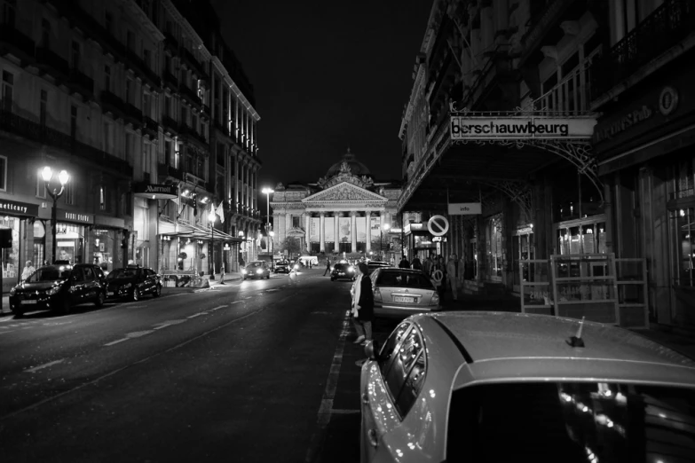 a street with parked cars next to a building