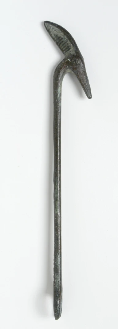 a metal object on white table and a metal stick