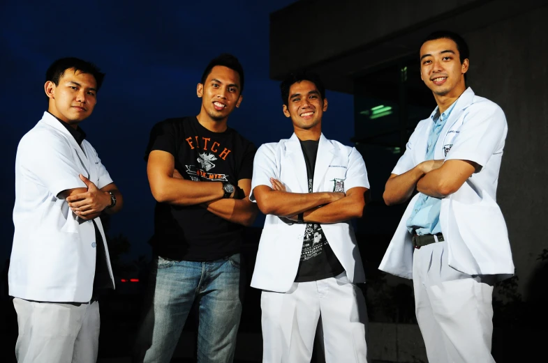 four men are standing together posing for a picture