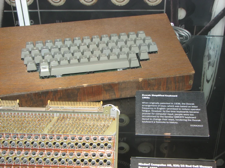 a wooden box holding a vintage computer keyboard