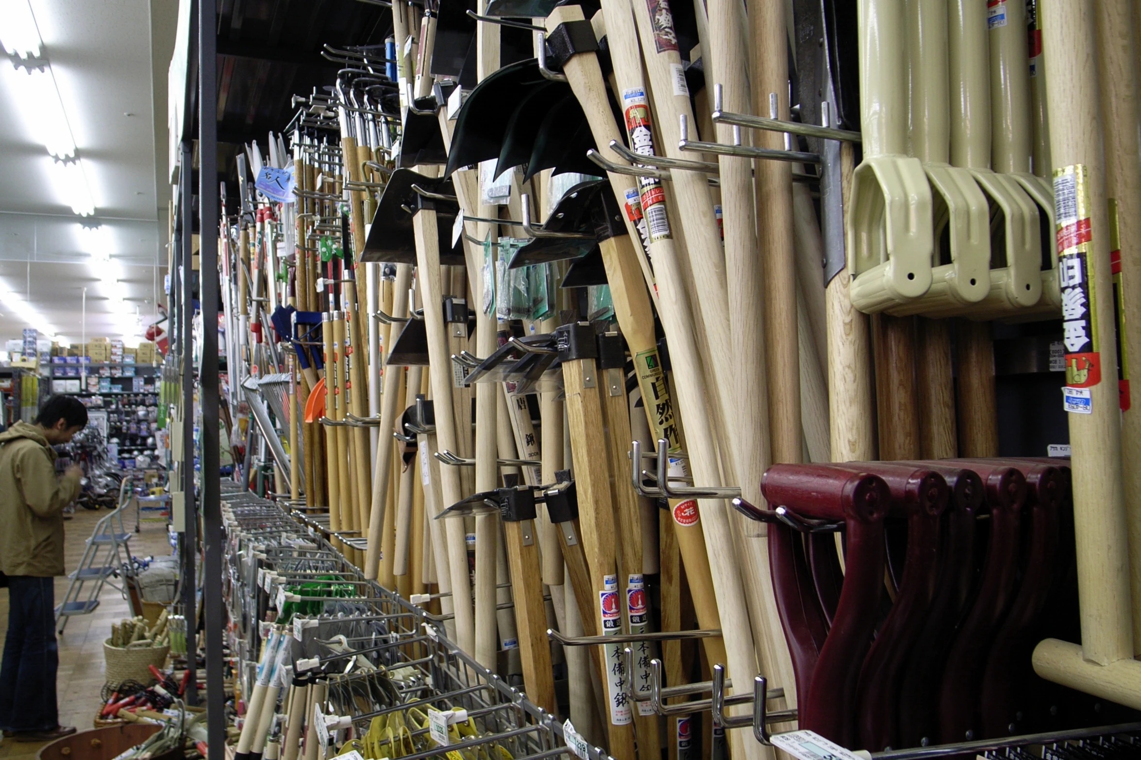 many baseball bats and hats on display in a store