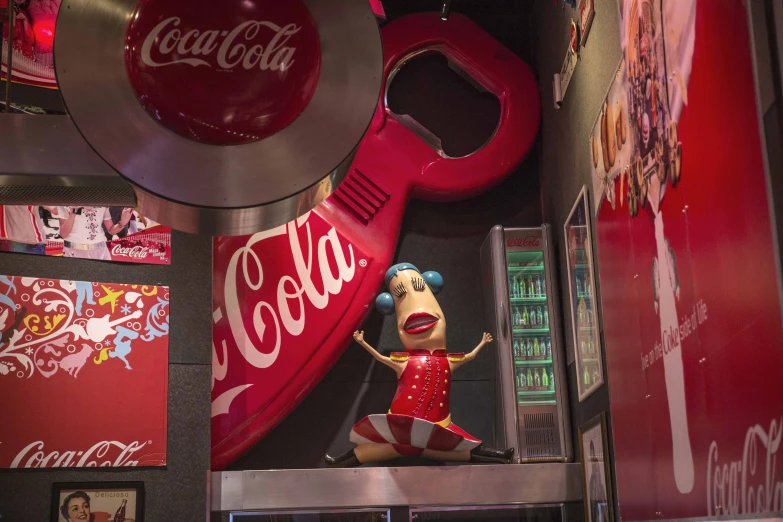 the large stuffed bird is in front of a coca - cola machine