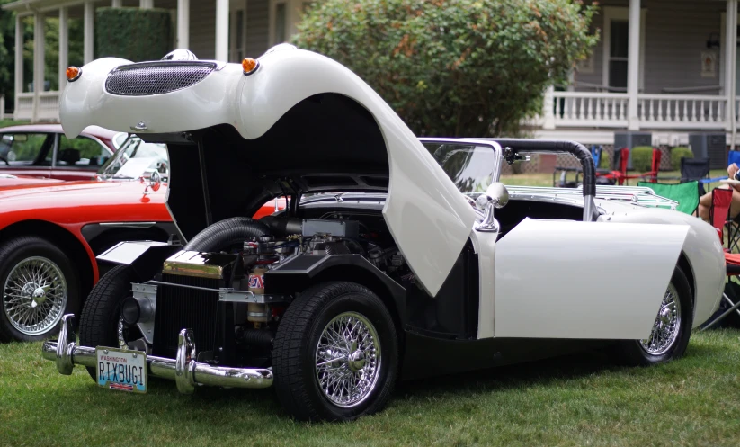 classic cars parked in the grass on display