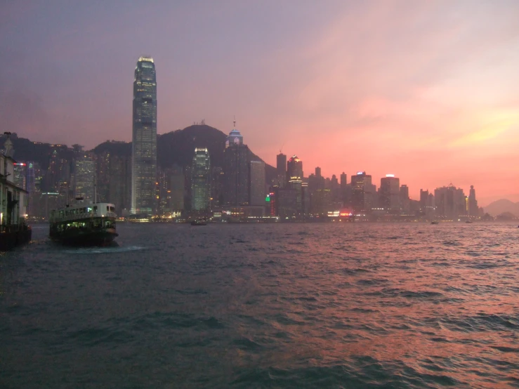 a body of water with boats in front of a large city