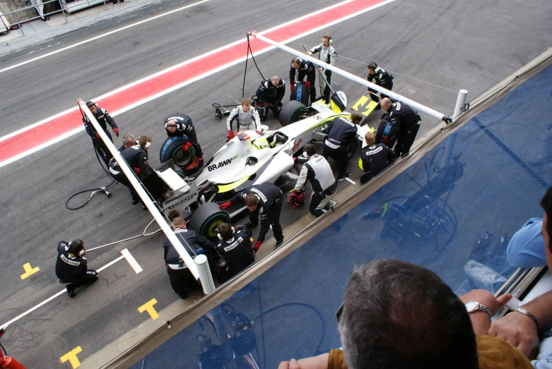 a pit is being prepared by mechanics on the track