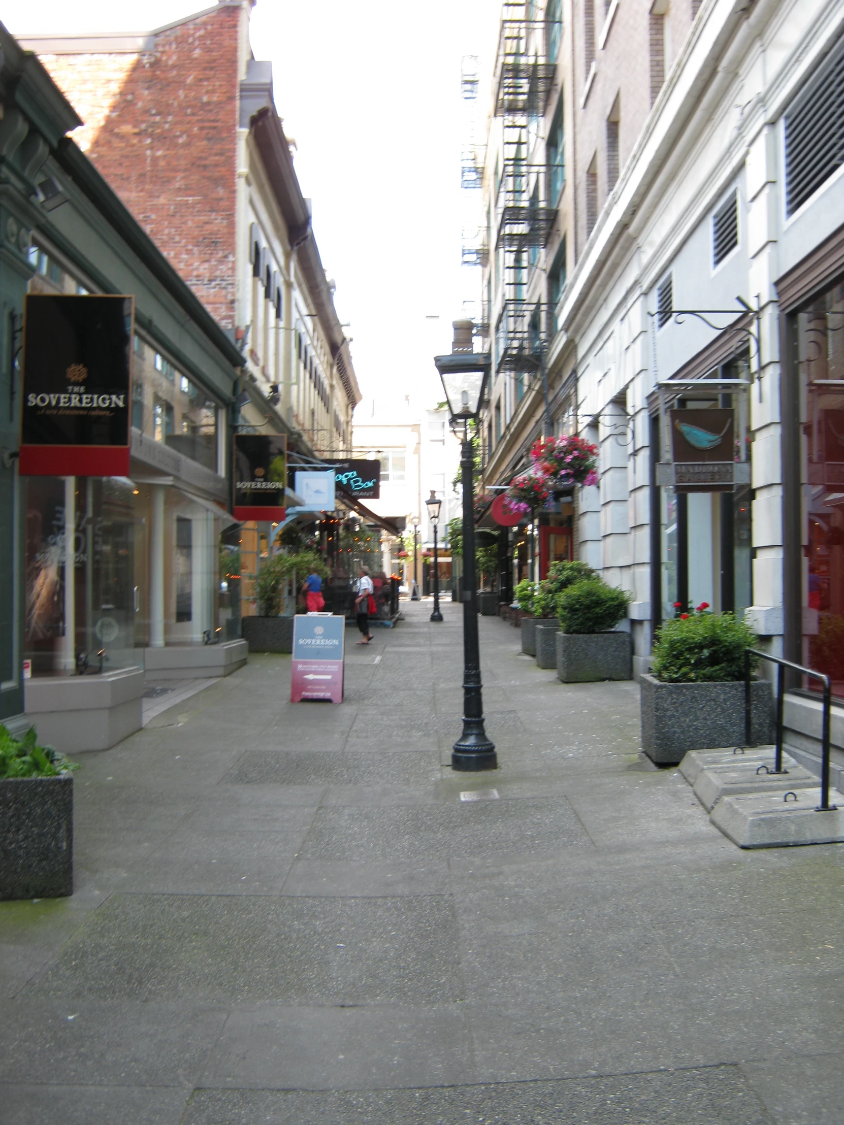 a city street with small buildings and a lamppost