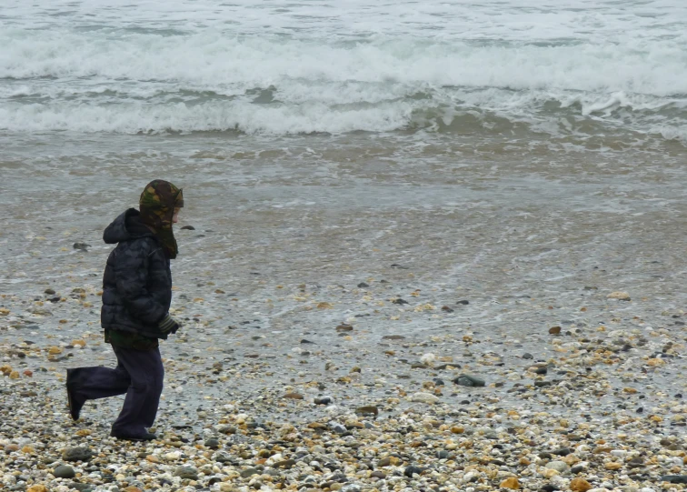 a  on the beach with his feet in the water