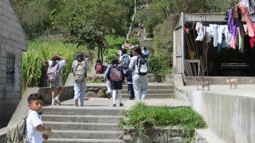 several people are walking down the stone steps