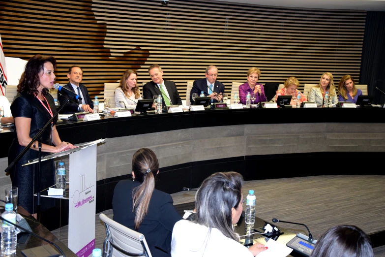 people at a large meeting talking at different tables