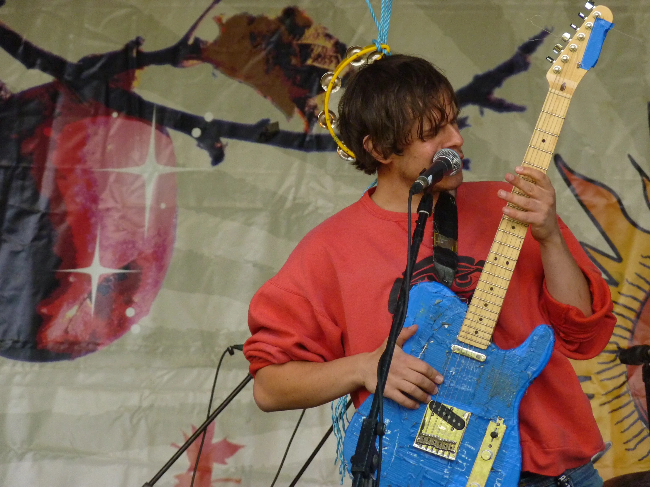 a young man playing a guitar while singing