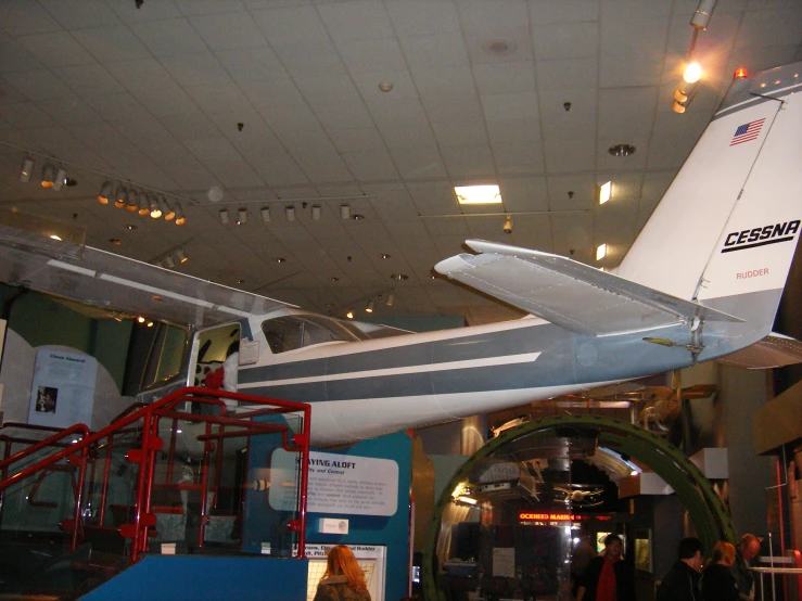 an airplane displayed in the museum as people observe it