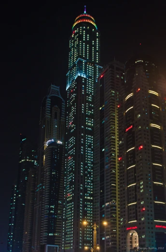a city with lots of tall buildings in the night time