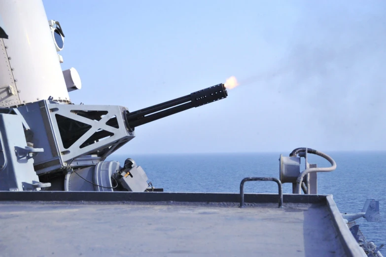 a gun is hooked up to the front of a military ship