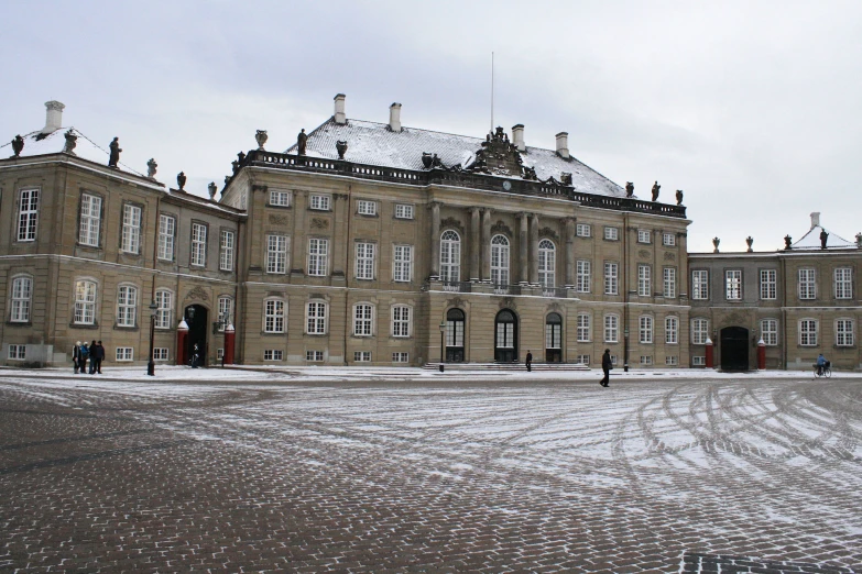 the building has snow on the ground in front