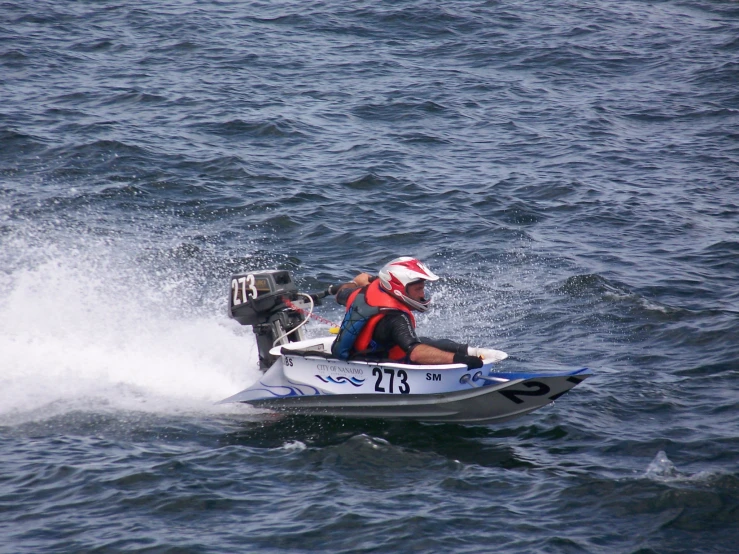 two men in a motorboat in the water