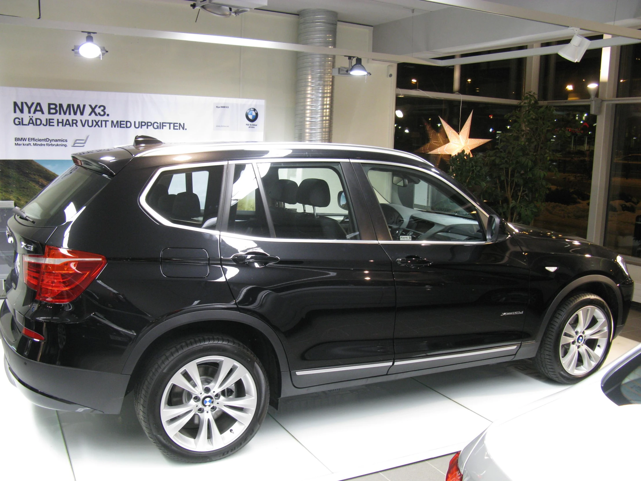 bmw luxury car displayed in indoor showroom during day