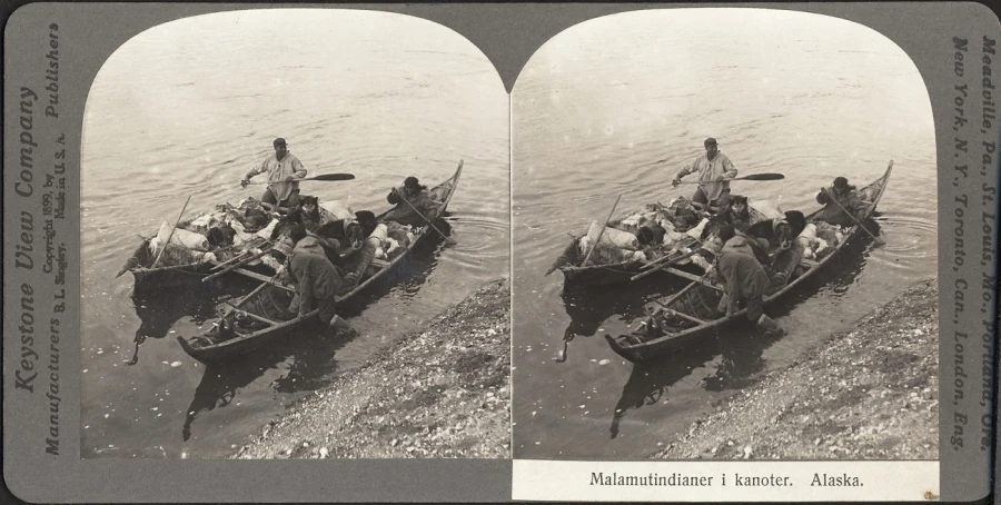 an old black and white po of people in boat in water