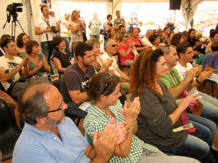 people sitting together as a man stands before them