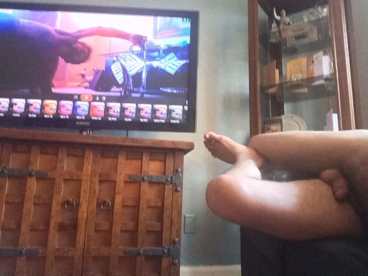 a person's feet are propped up against the television