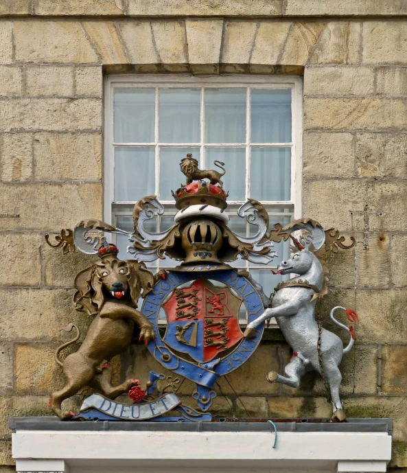 a coat of arms with lion rampants adorns a window