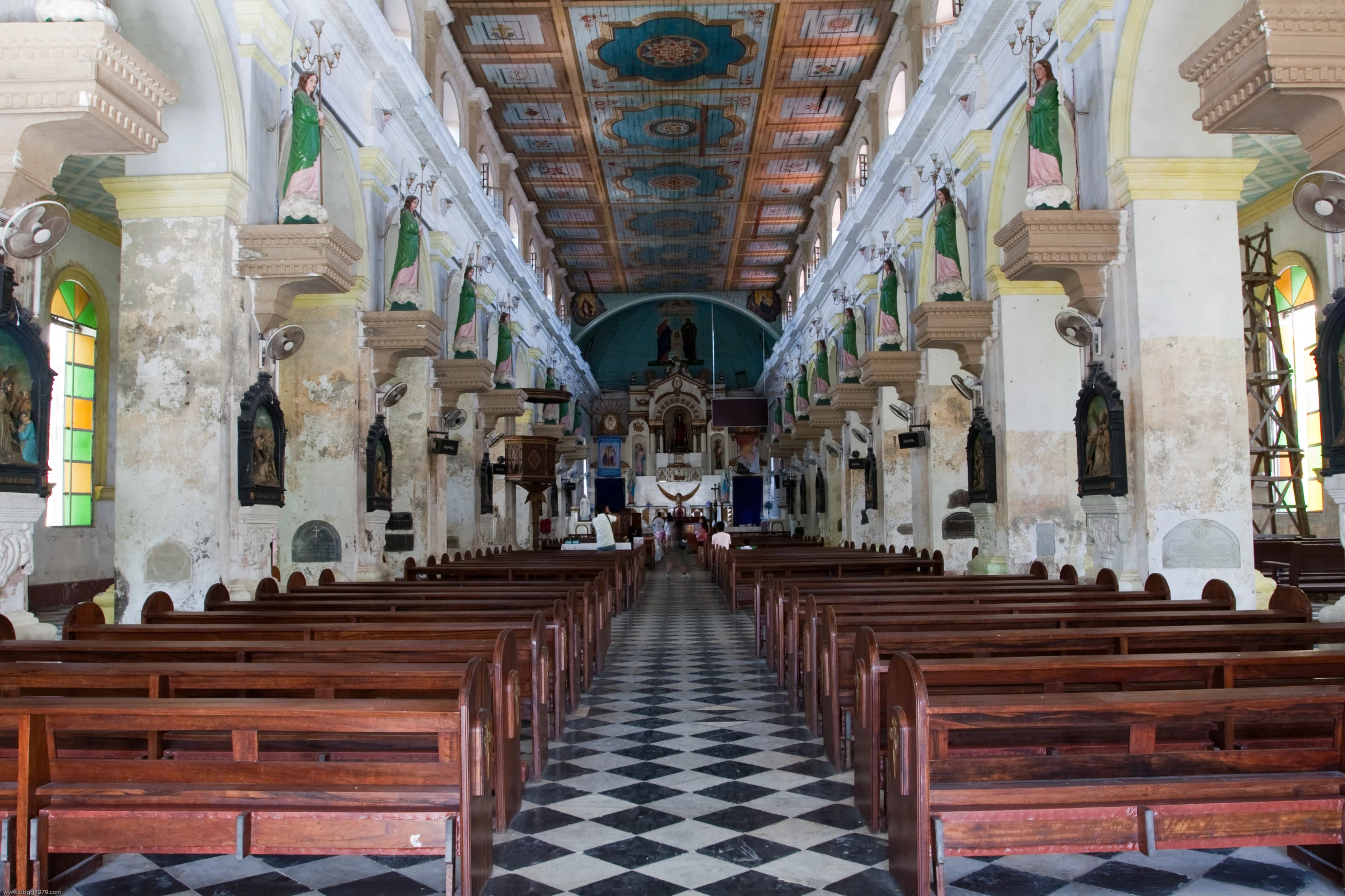 an old church with pews and arches lined with cloths