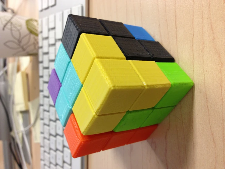 a group of multi - colored rubels siting on a wooden desk