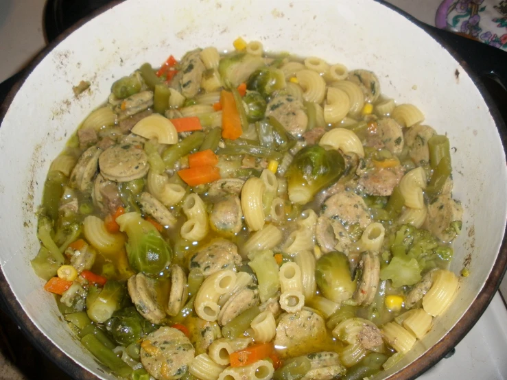 a bowl full of a stew of pasta and vegetables