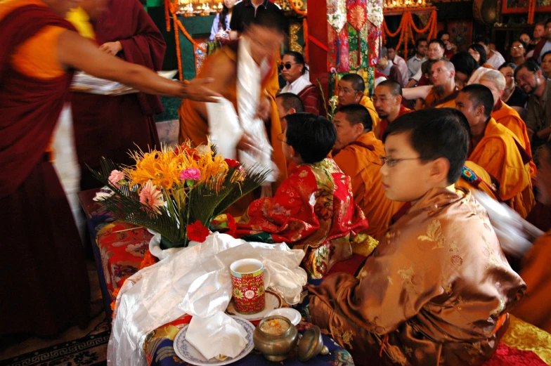 a group of people in robes and candles