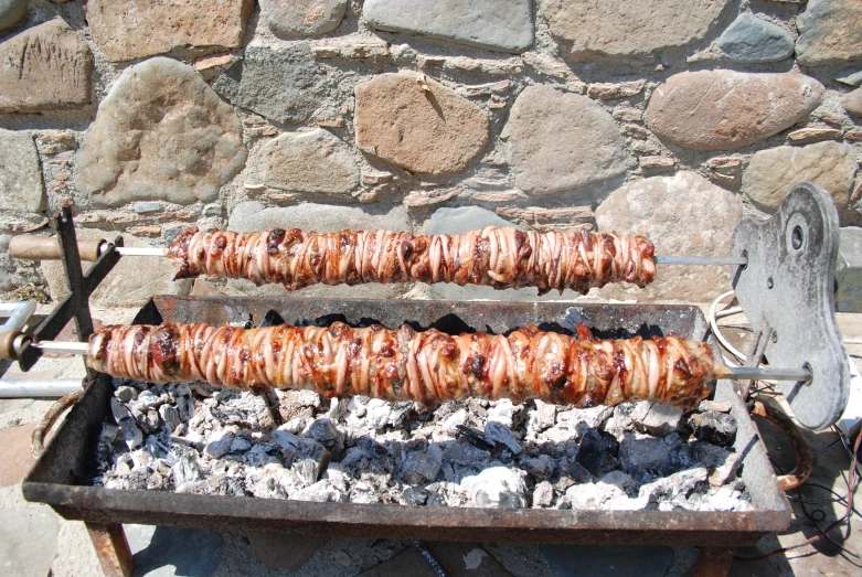a grill that has several skewers of food on it