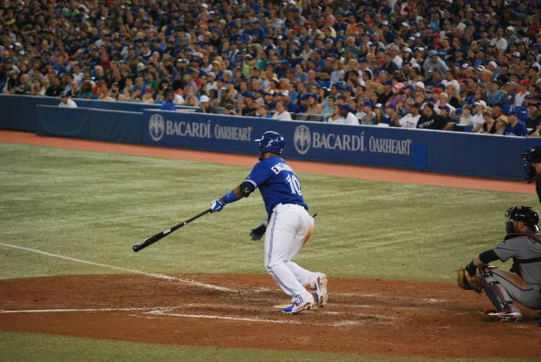 a baseball player is swinging a bat at a baseball game