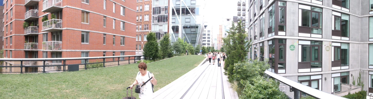 a group of people standing near some tall buildings