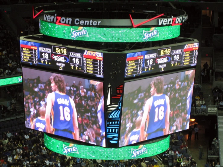 a large basketball scoreboard shows a huge game