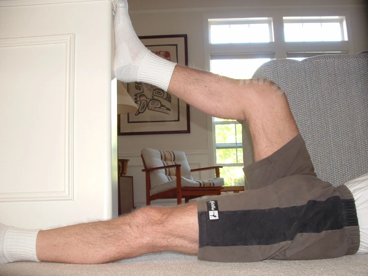 man lying on the floor with white socks on