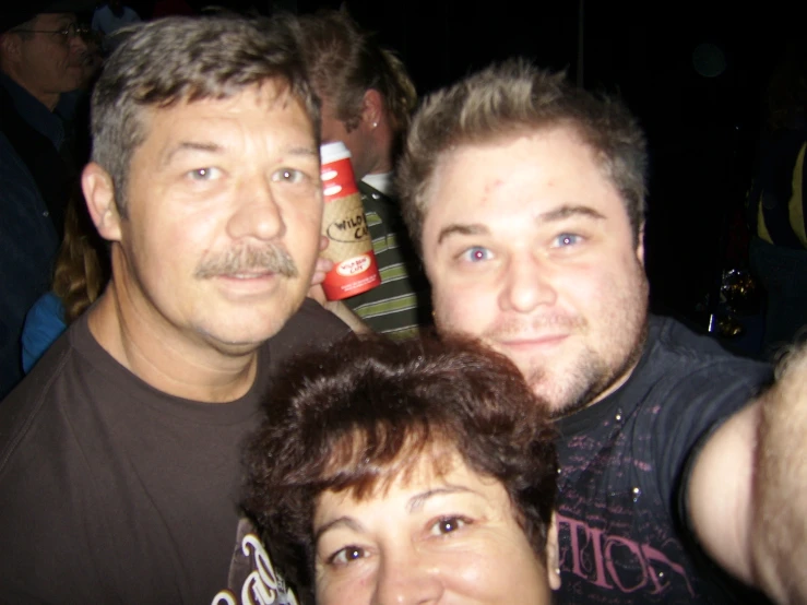 three people posing for the camera together at a party