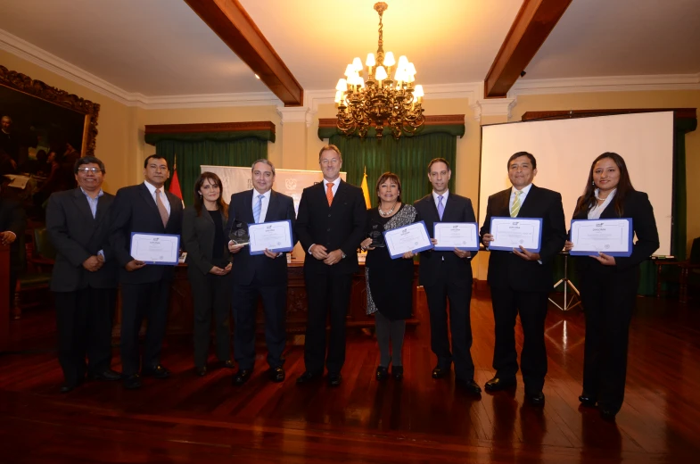 a group of people posing with some very large awards