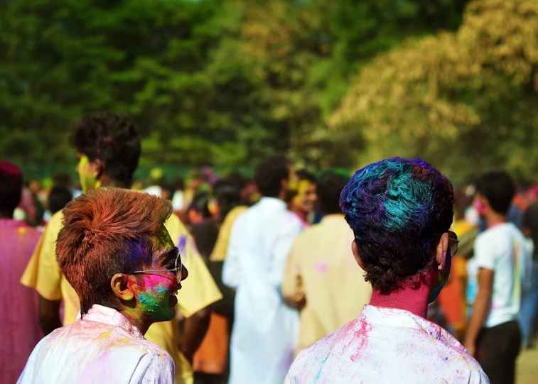 several people dressed up and wearing colorful paint on their faces