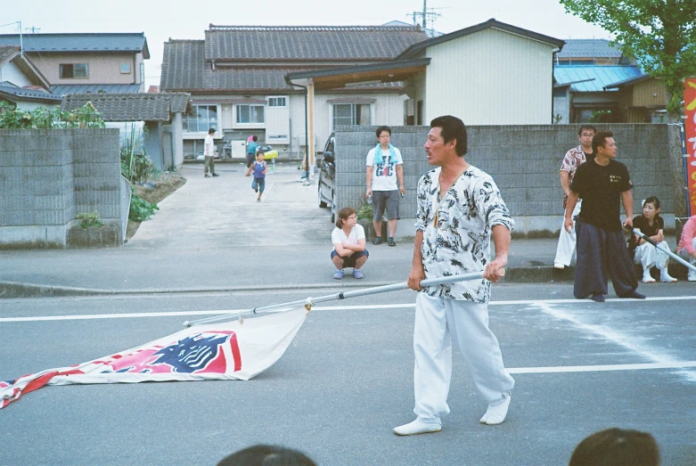 a man with an american flag kite in front of a crowd