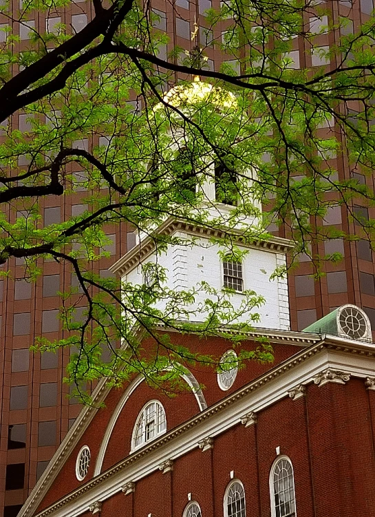 a tall red brick building with a steeple on top