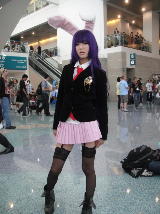 a girl with purple hair wearing black and pink outfit