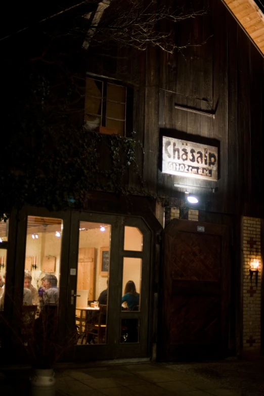 dark picture of restaurant at night time with sign on the building