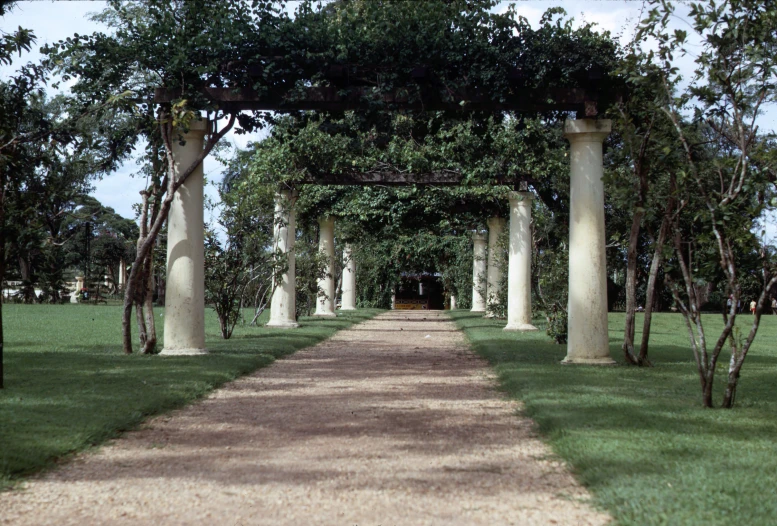 a pathway leading to a lush green park