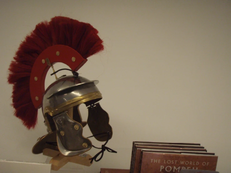 a helmet is placed on top of a book shelf