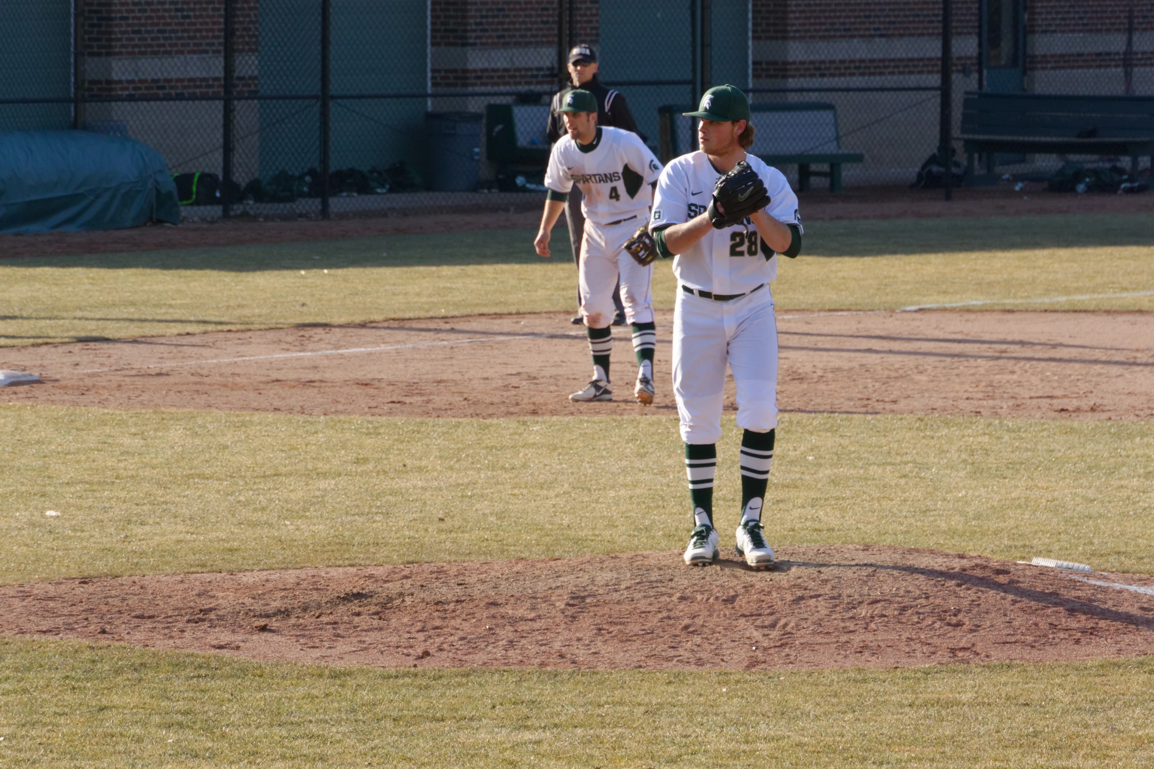 the three baseball players are all about ready to play